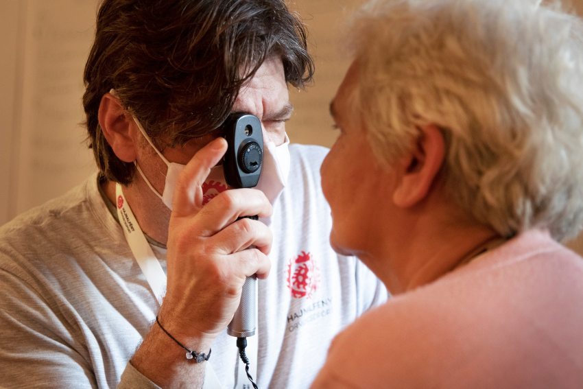 László Szalai examining a patient's eye