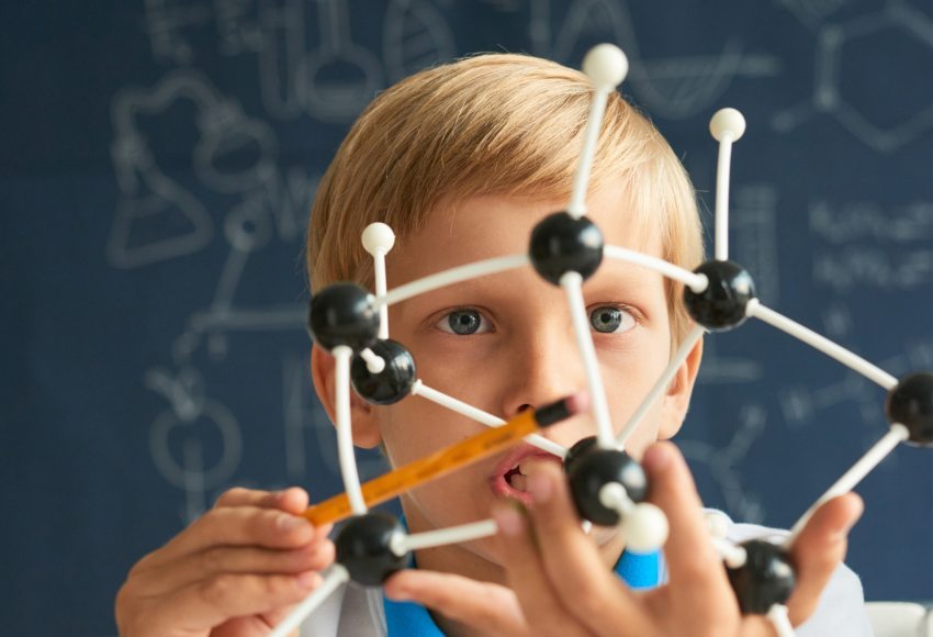 A child playing with a molecule model