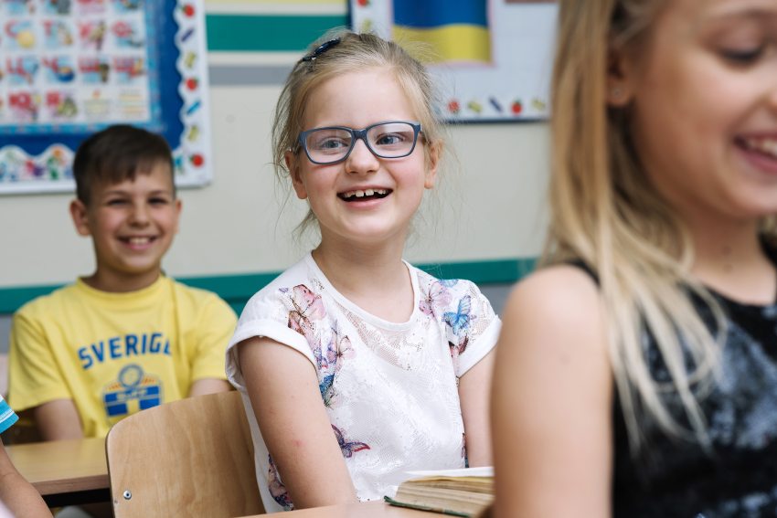 pedagógus diákjai mosolyogva ülnek a padban