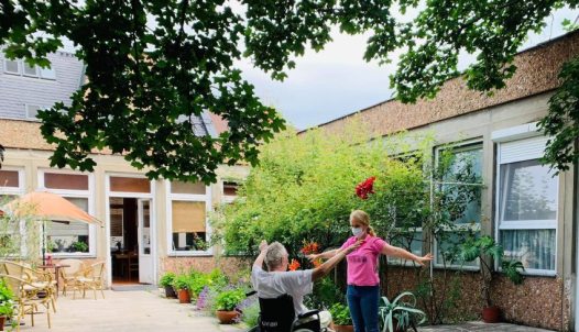 Patient and caregiver on the patio of a hospice house