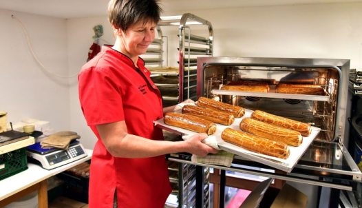 Zsuzsa Kiss Károlyné with several rolls of beigli
