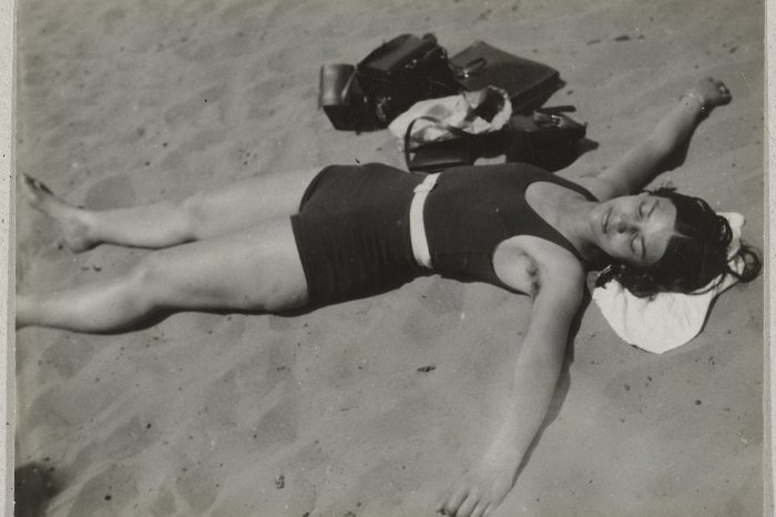Éva Besnyő lying in the sand on a beach in 1931