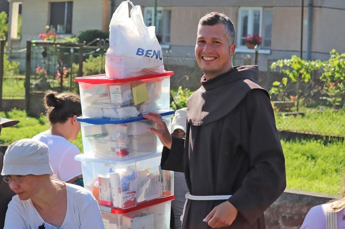 Mihály Zillich with piles of humanitarian aid
