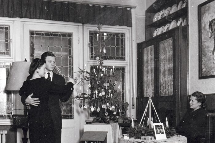 A couple in front of a Christmas tree in 1959