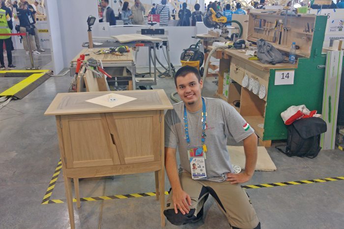 Krisztián Simon with the cabinet he made