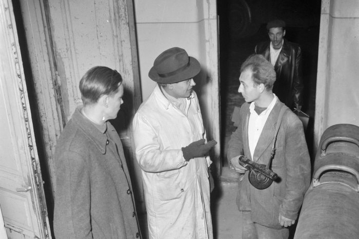 23 October 1956 Budapest, international journalists talking to an armed man