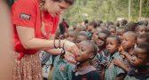 Zsófia Szilágyi-Könczöl distributing medicines during the annual anthelmintic treatment to children attending the association's school, October 2023, Manafwa, Uganda