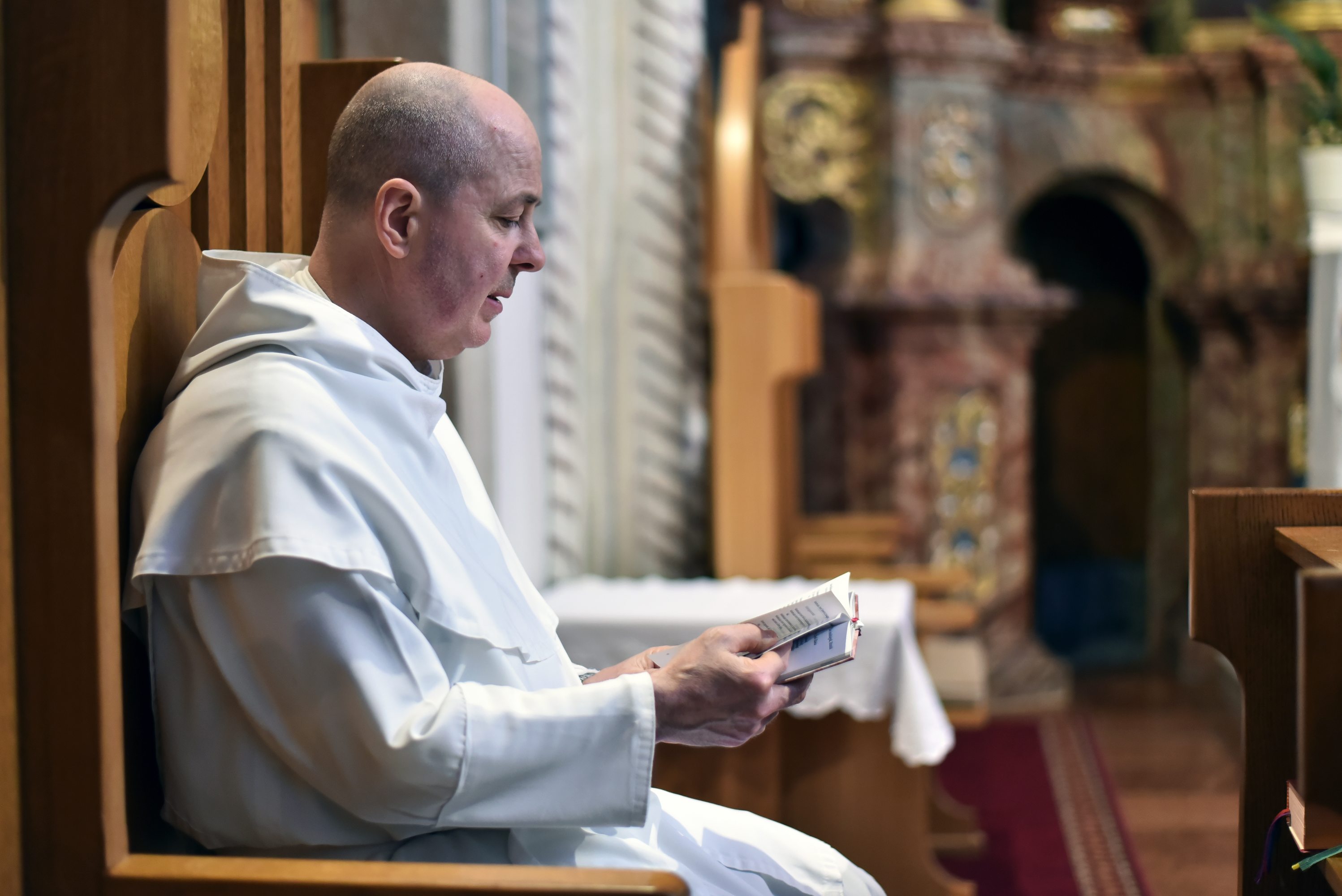 Pauline monk praying at an evening prayer