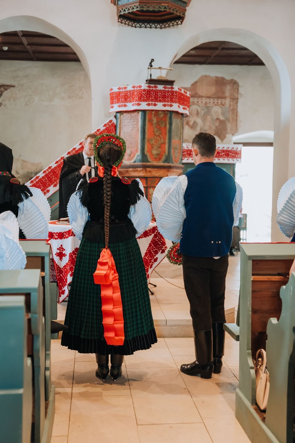 The couple before the altar at their wedding