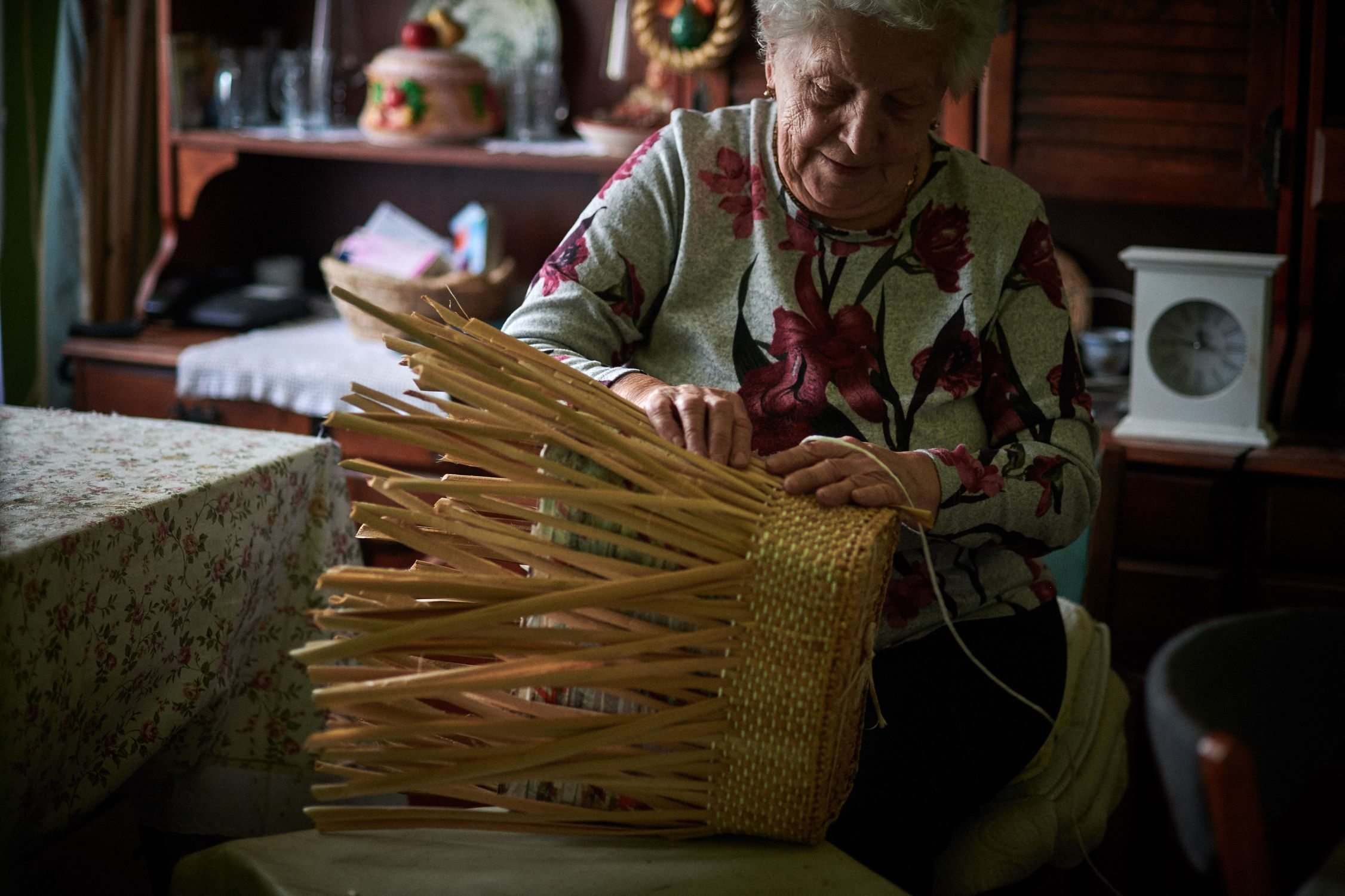 Mrs Elvira showing how to weave cattail baskets