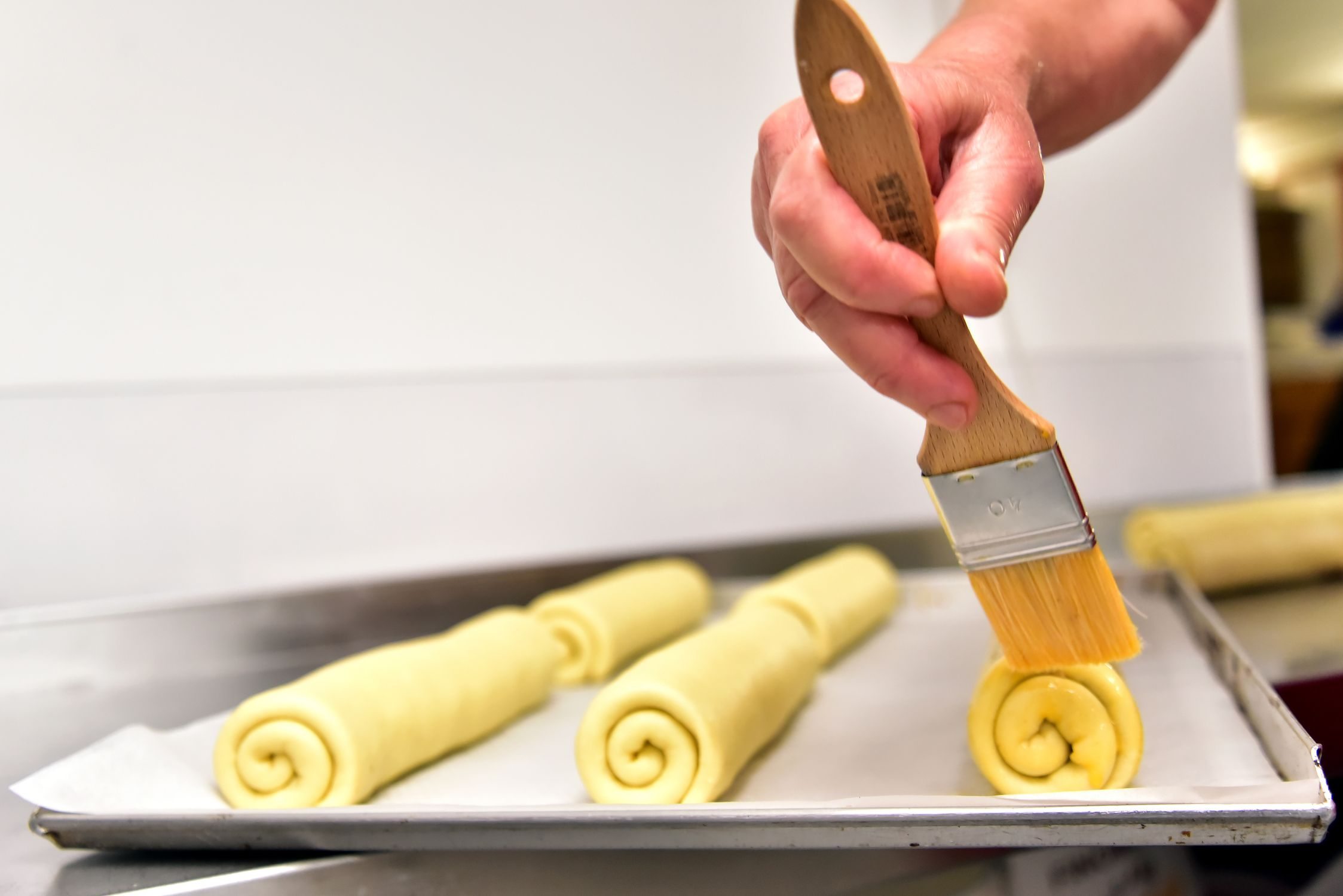 brushing the top of the rolls with egg mixture