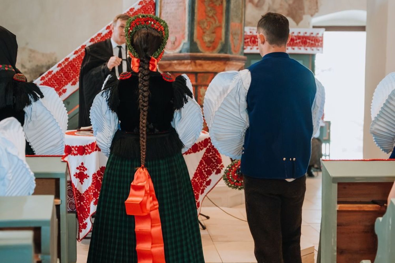 The couple before the altar at their wedding