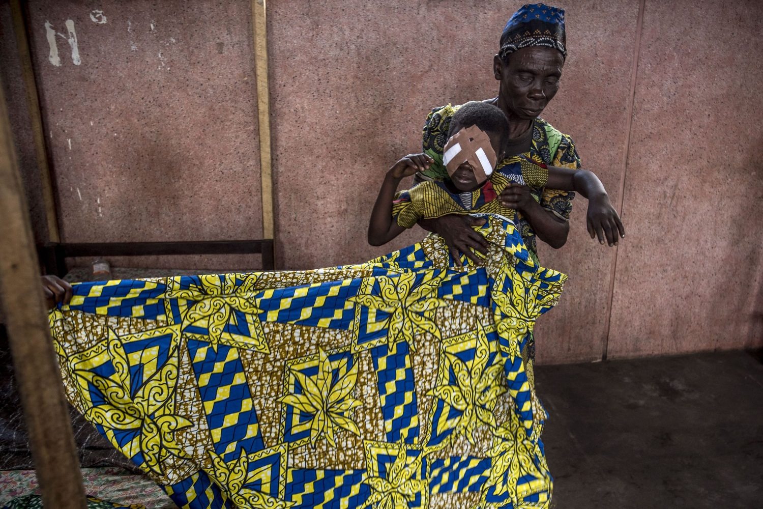 A woman carrying a girl after catarct surgery in the Congo