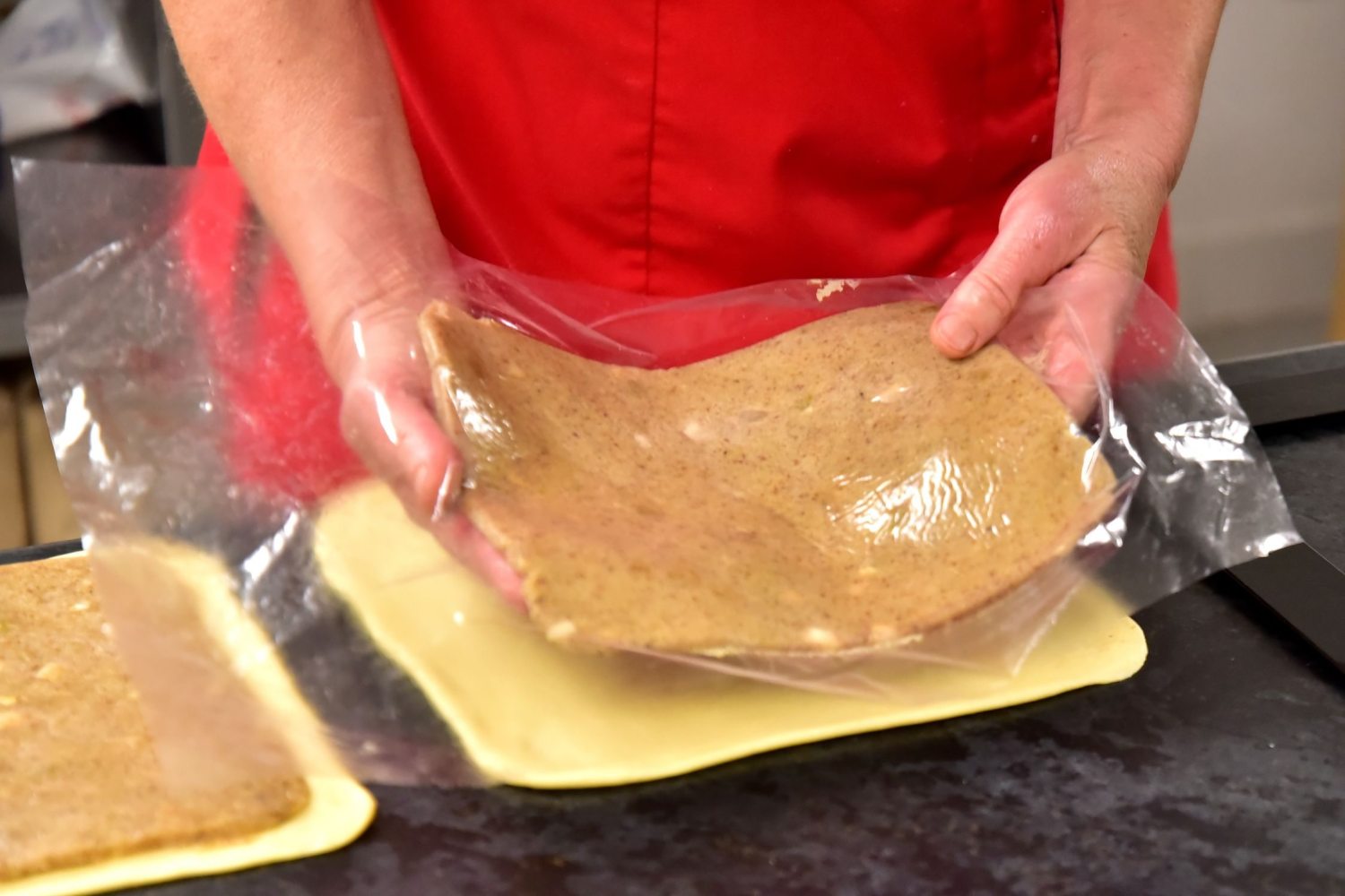 placing the flattened filling on the flattened dough