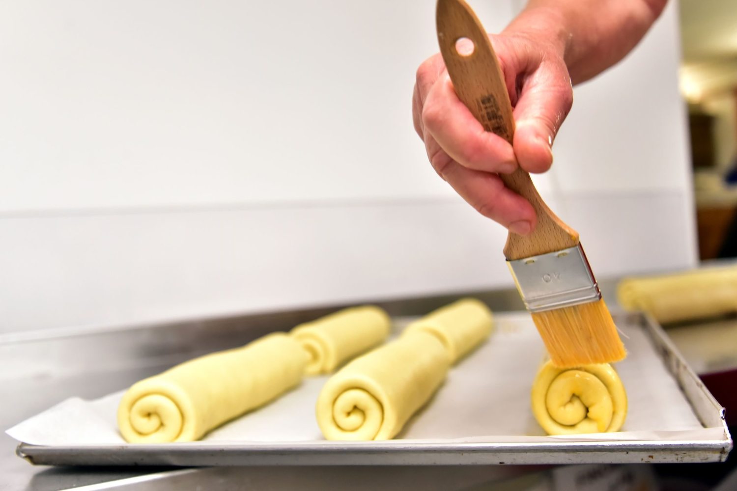 brushing the top of the rolls with egg mixture